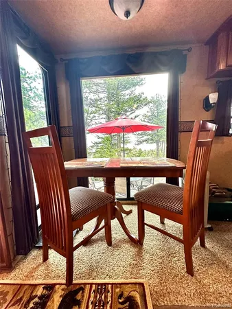 a kitchen with kitchen island granite countertop a sink stainless steel appliances and furniture