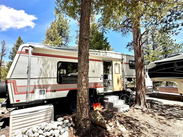 a utility room with stainless steel appliances kitchen island granite countertop a sink and cabinets