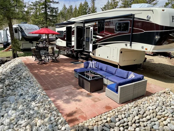 a view of a backyard with table and chairs and a fire pit
