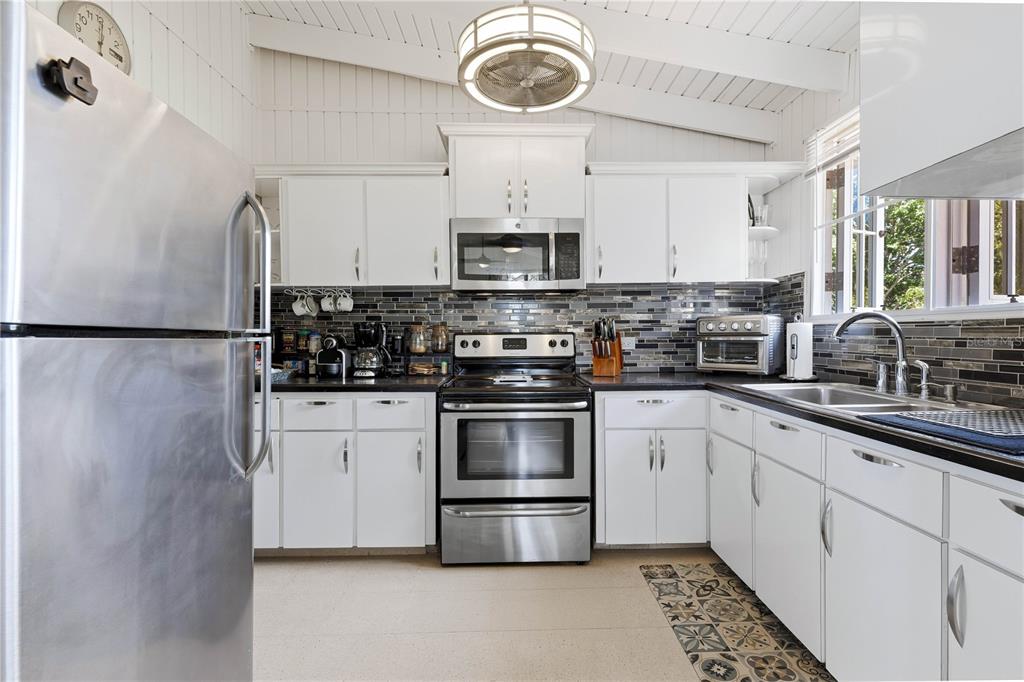 1 Gil Bouyet Street Cabo Rojo, PR 00623 - Photo 13 of 24 a kitchen with stainless steel appliances a stove a sink and a microwave