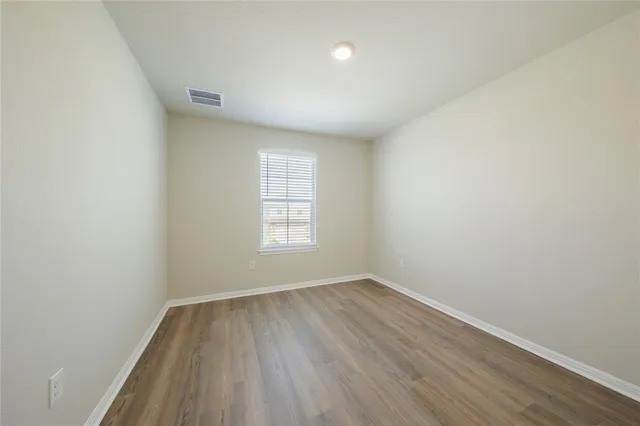 a view of an empty room and wooden floor