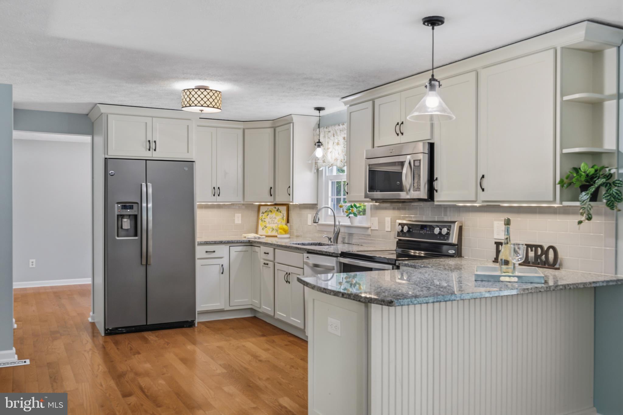 1506 Gollum Road Hanover, MD 21076 - Photo 14 of 44 a kitchen with stainless steel appliances granite countertop a refrigerator a stove a sink and a granite counter tops