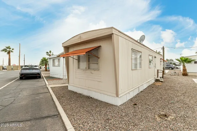 a view of a house with a backyard