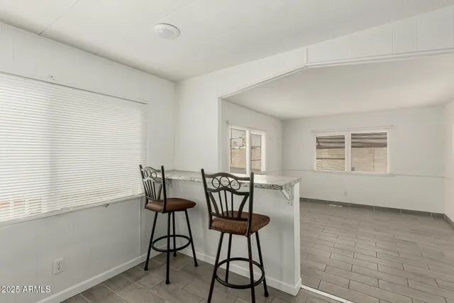 a view of a room with furniture and windows