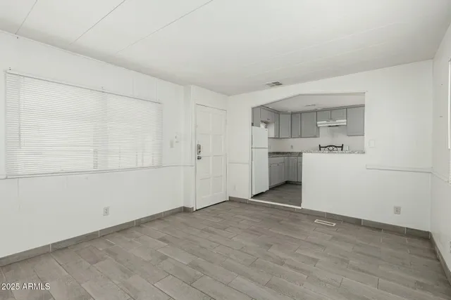 a view of a kitchen with wooden floor and a kitchen