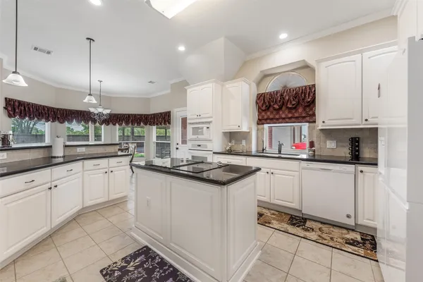 a kitchen with stainless steel appliances granite countertop a sink and cabinets