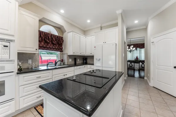 a kitchen that has a sink and a stove in it