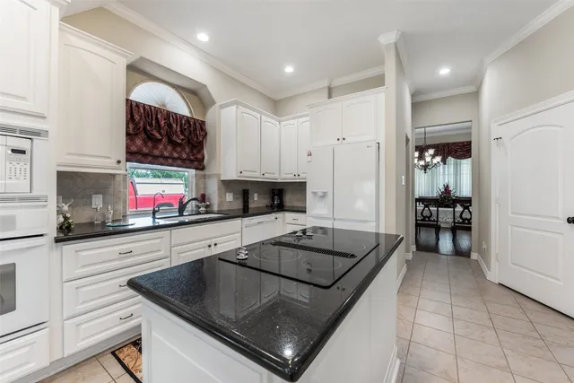 a kitchen that has a sink and a stove in it