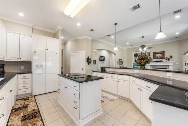 a kitchen with white cabinets appliances and a sink