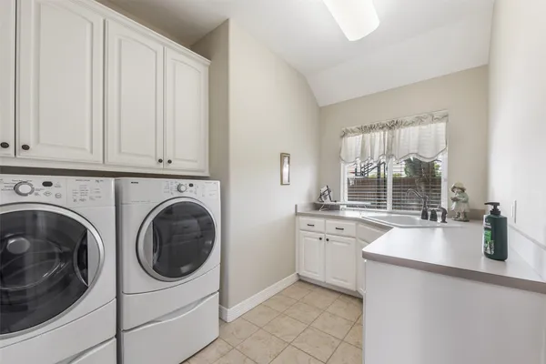 a kitchen with a sink and a washer dryer