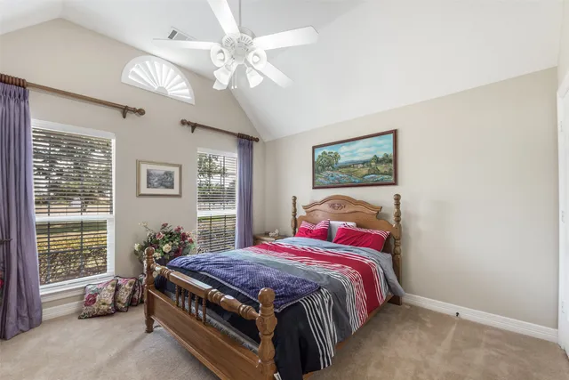 a bed sitting in a bedroom next to a window