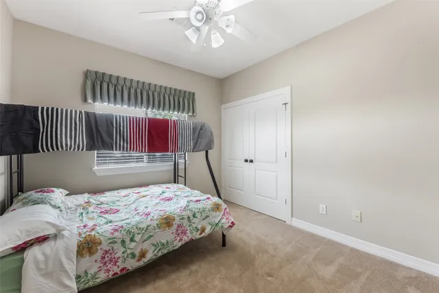 a bedroom that has a bed and a table in it