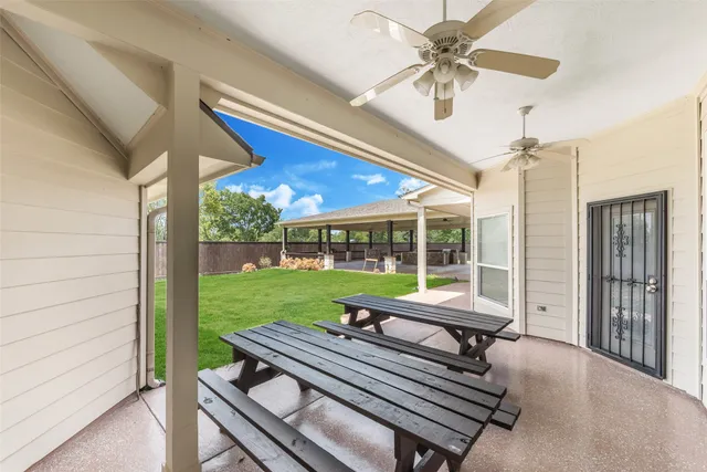 a view of a patio with a table and chairs