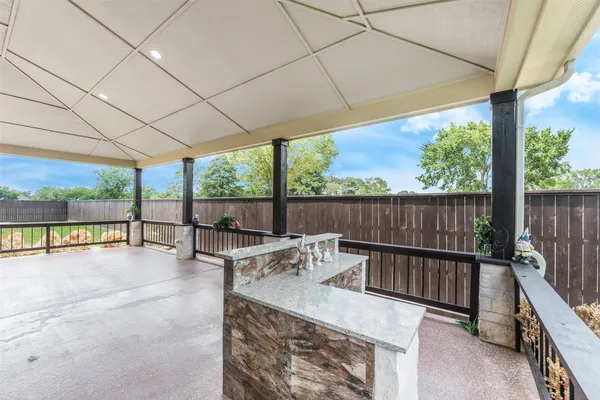 a view of a patio with a table chairs and a patio
