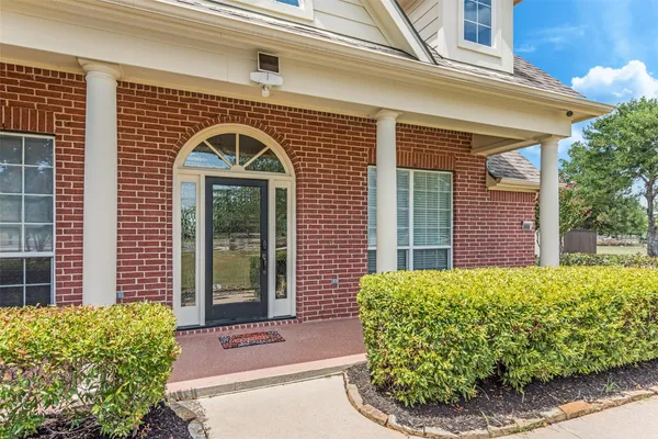 a view of a brick house with potted plants
