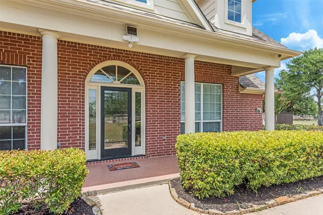 a view of a brick house with potted plants