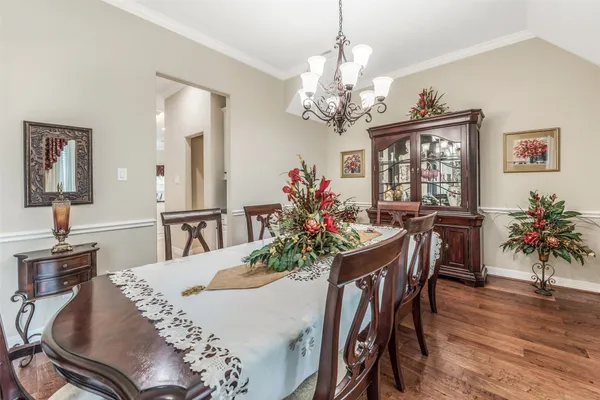 a view of a dining room with furniture and chandelier