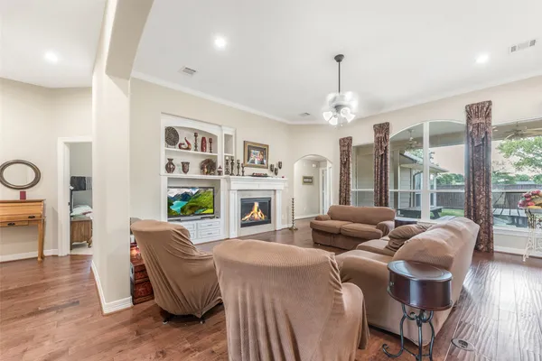 a living room with furniture a fireplace and a large window