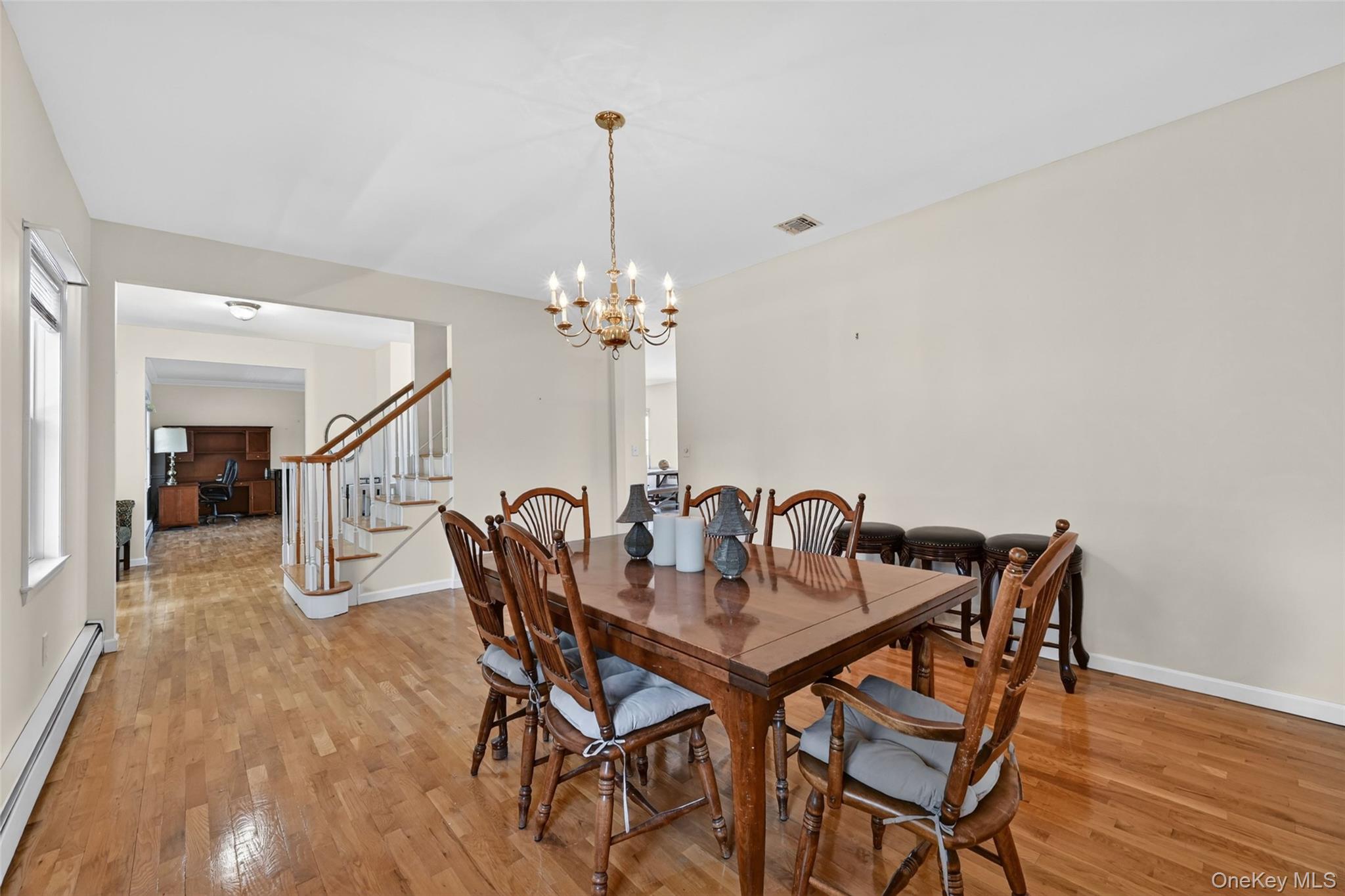 19 Bull Mine Road Chester, NY 10918 - Photo 9 of 42 Dining area featuring wood-finish flooring, a brass chandelier, and light-toned wall paint