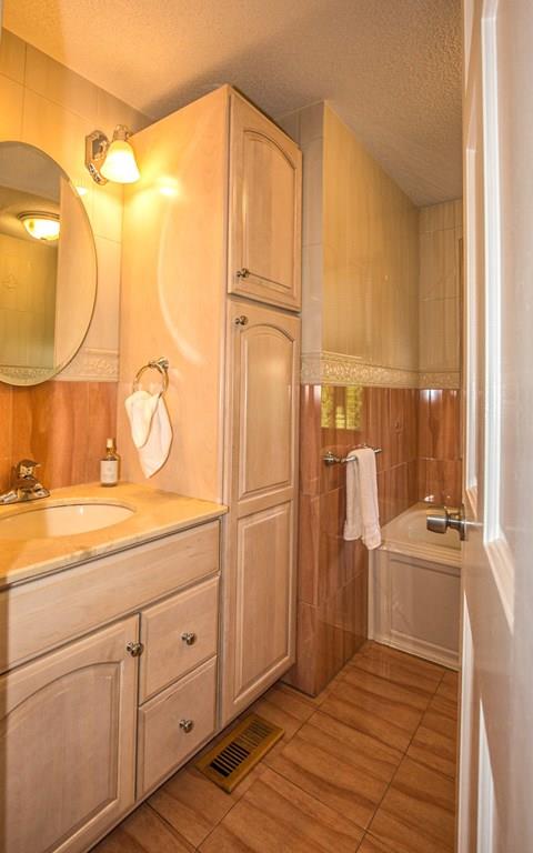 44 Quentin Road Springfield, MA 01129 - Photo 17 of 40 a bathroom with a sink a mirror and a shower