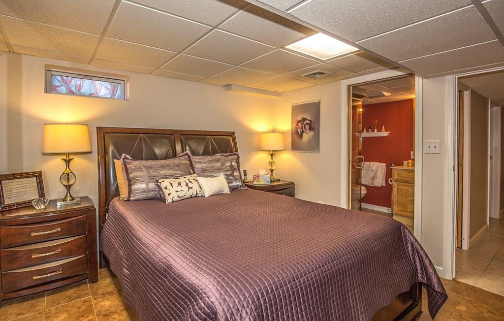 44 Quentin Road Springfield, MA 01129 - Photo 27 of 40 a bedroom with a bed and a lamp on dresser