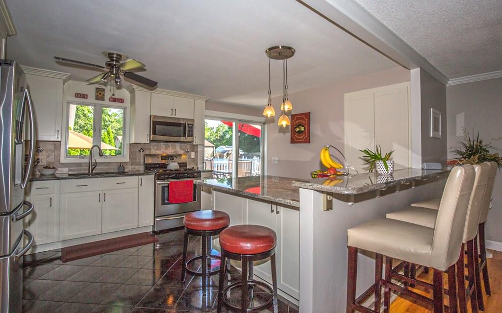 44 Quentin Road Springfield, MA 01129 - Photo 5 of 40 a kitchen with stainless steel appliances granite countertop sink cabinets and wooden floor