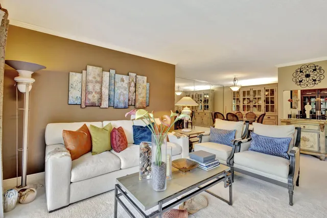 a living room with lots of furniture and a book shelf