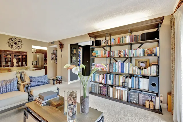 a living room with furniture and a floor to ceiling window