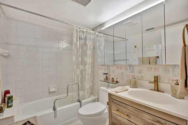 a bedroom with a bed couch and a window