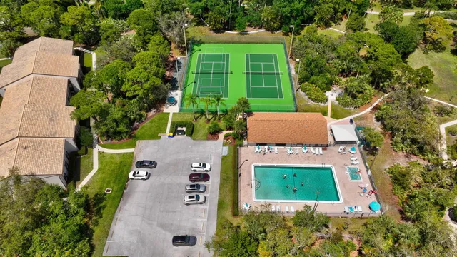 a view of a house with swimming pool and a yard