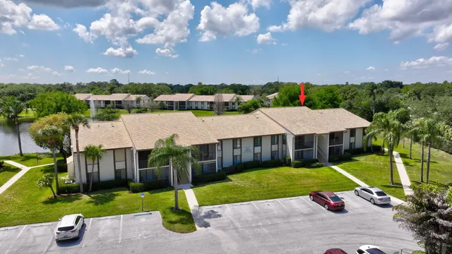 an aerial view of residential houses with outdoor space and swimming pool