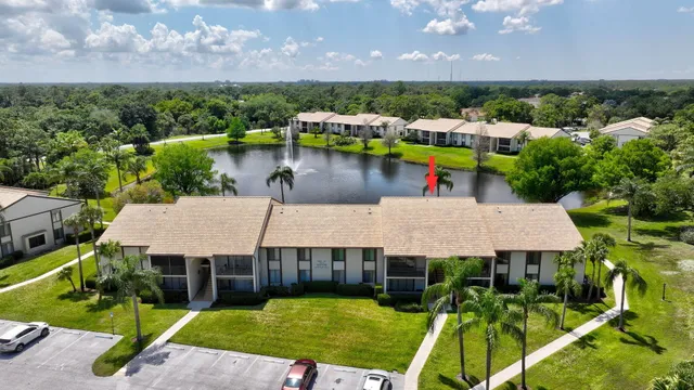 an aerial view of a house with a yard lake view and city view