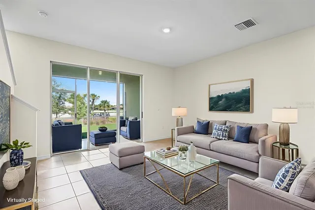 a living room with furniture and flowers