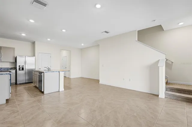 a view of kitchen with kitchen island and stainless steel appliances