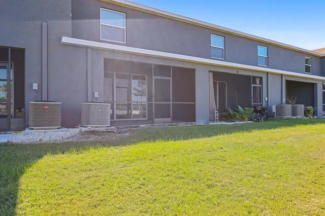 a swimming pool with outdoor seating and yard