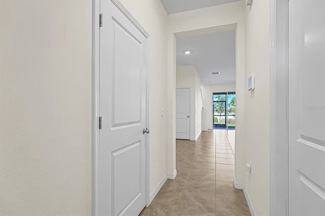 a view of a hallway with wooden floor