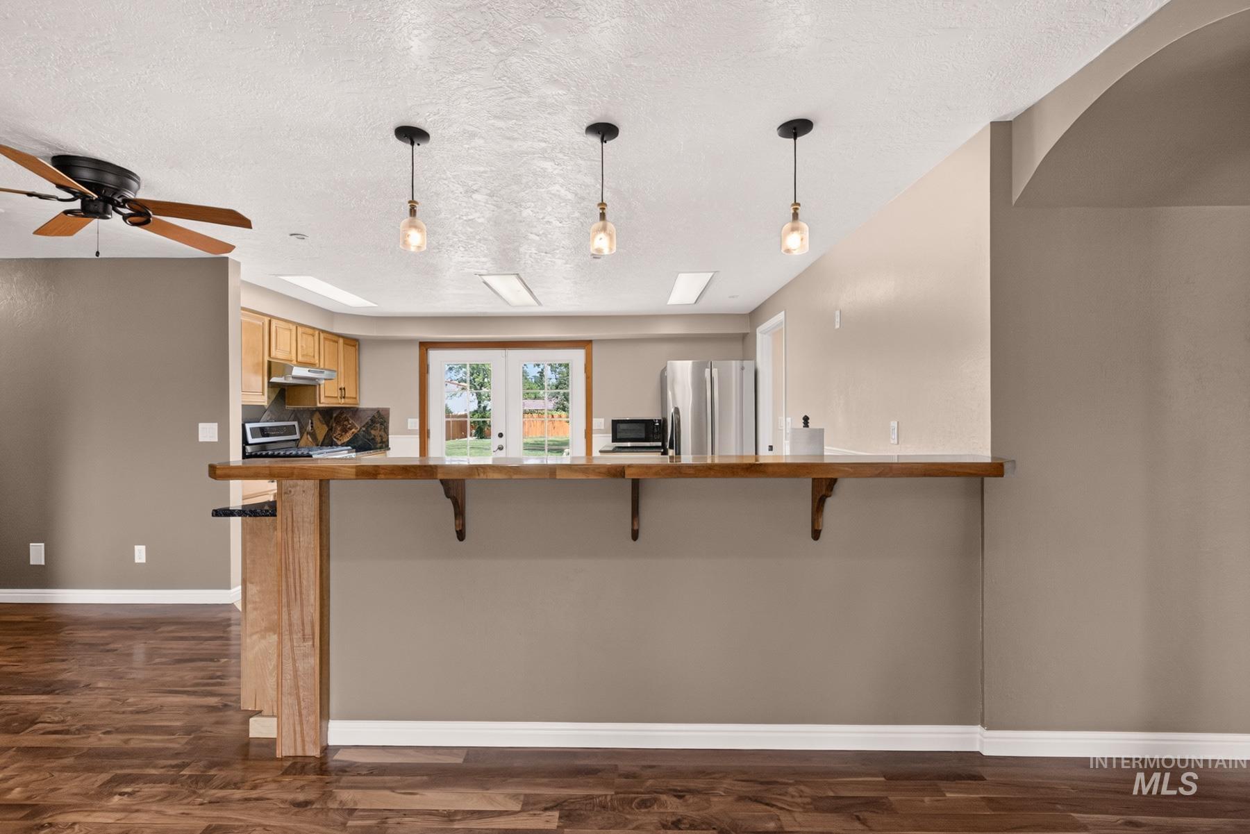 9622 Delaware Street Boise, ID 83709 - Photo 13 of 48 Open-concept kitchen featuring light wood cabinetry, white countertops, stainless steel appliances, and French doors