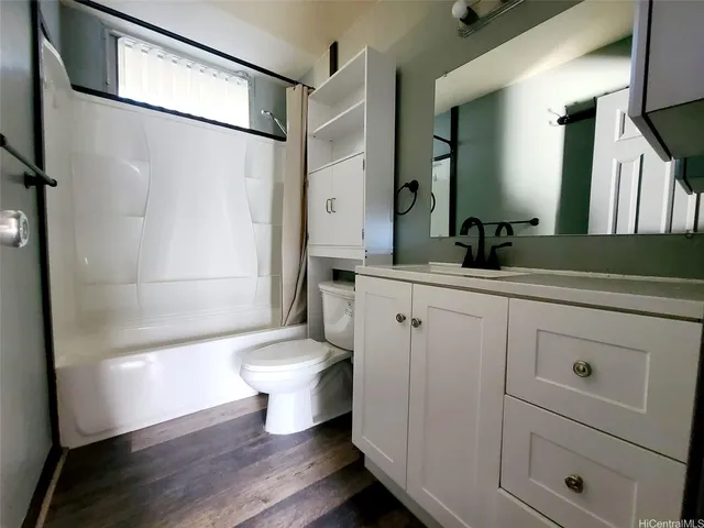 a bathroom with a toilet a sink and a mirror