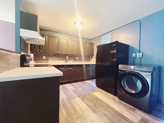 a kitchen with a sink cabinets and stainless steel appliances