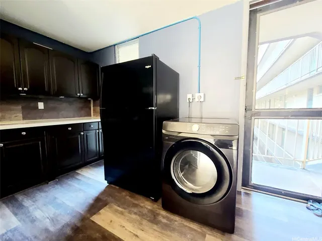 a kitchen with a refrigerator and a sink