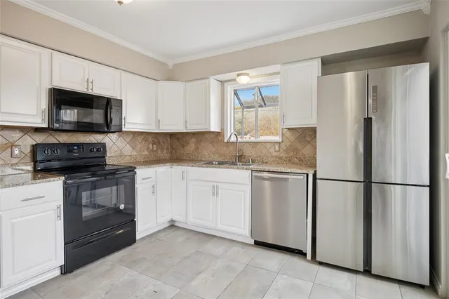 a kitchen with stainless steel appliances granite countertop cabinets and a refrigerator