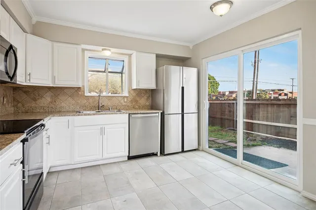 a kitchen with appliances cabinets and a sink