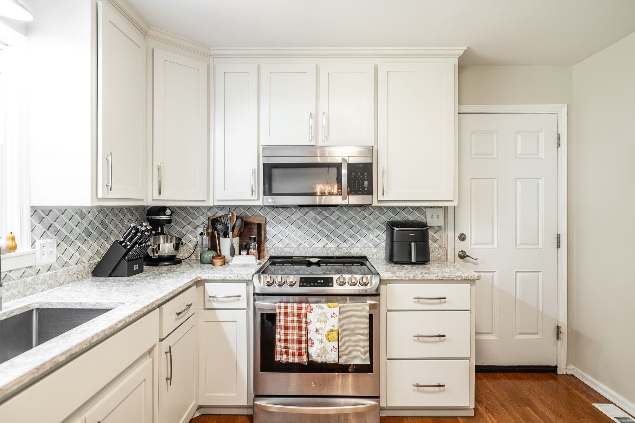 2714 Morgan Road Joelton, TN 37080 - Photo 15 of 78 a kitchen with granite countertop white cabinets and stainless steel appliances