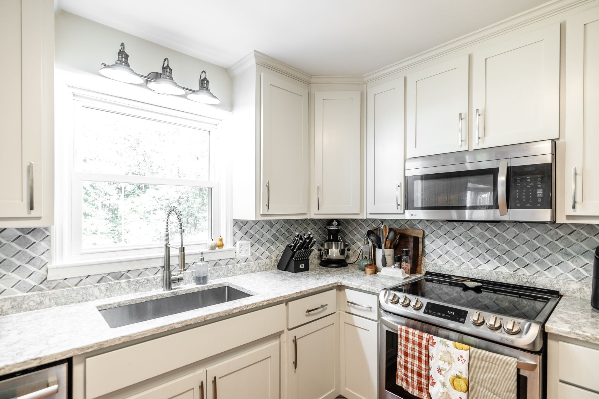 2714 Morgan Road Joelton, TN 37080 - Photo 16 of 78 a kitchen with granite countertop a sink a window stainless steel appliances and cabinets