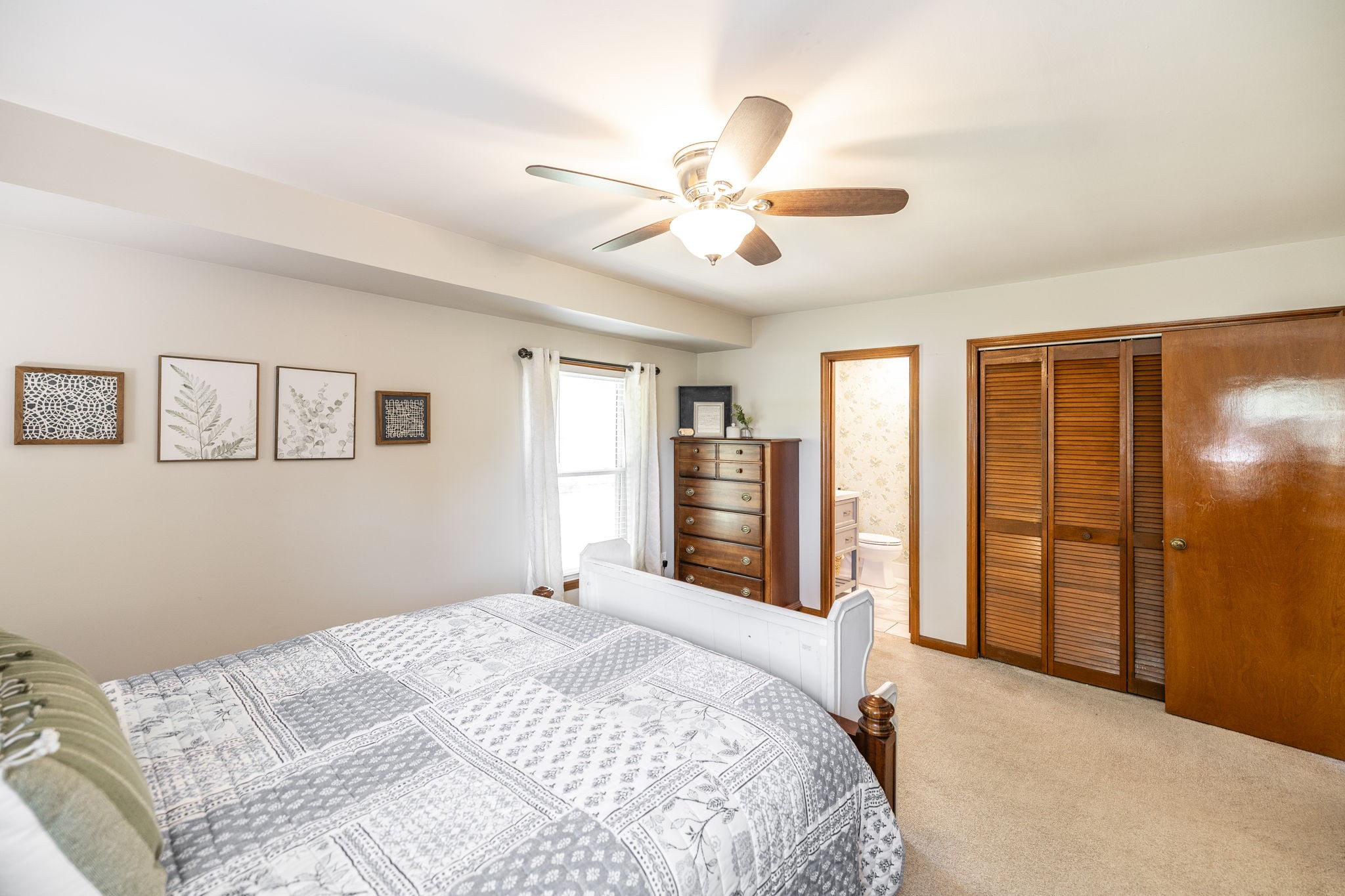 2714 Morgan Road Joelton, TN 37080 - Photo 50 of 78 a bedroom with a large bed and a chandelier