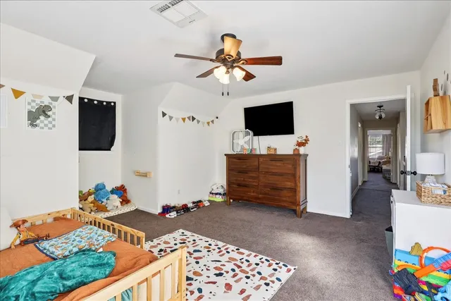 a bedroom with a bed and a flat tv screen on the wall