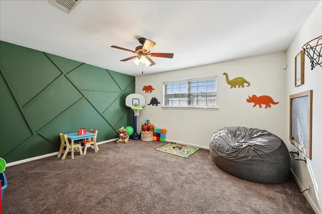 a bedroom with furniture and a fan