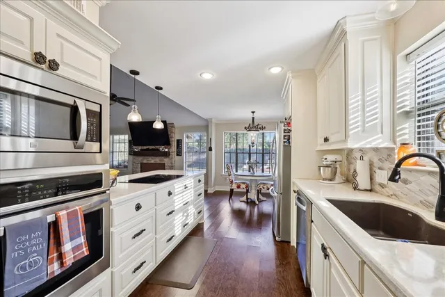 a kitchen with stainless steel appliances a stove sink microwave and cabinets