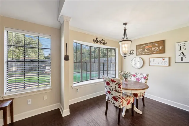 a dining room with furniture a rug and wooden floor