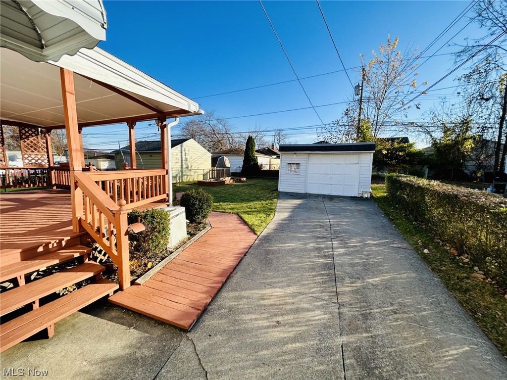 13414 Rockside Road Garfield Heights, OH 44125 - Photo 22 of 25 Deck featuring a yard and a garage